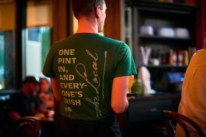 Waiter showing back of t-shirt for The Local Minneapolis swag